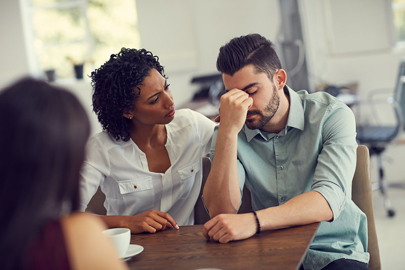 One person comforts another in a support group